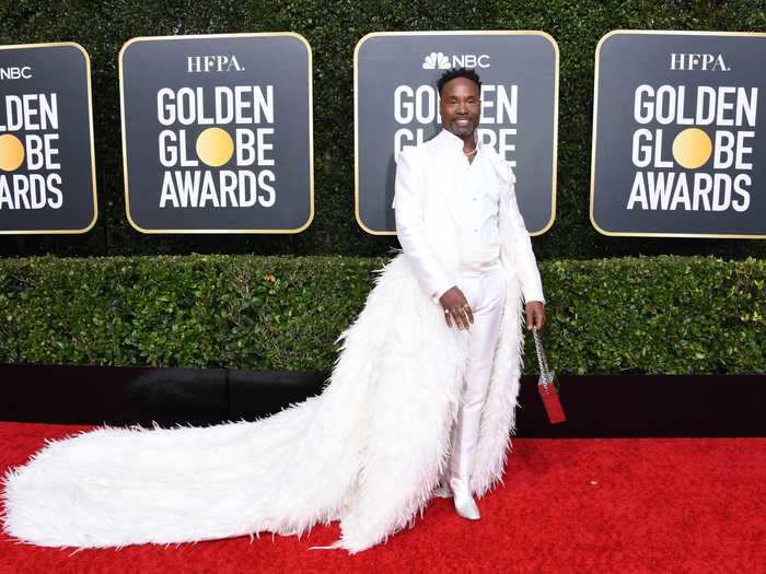 A year after he sported a hot-pink cape, Porter walked the Golden Globes red carpet in a white suit with a feathered train.