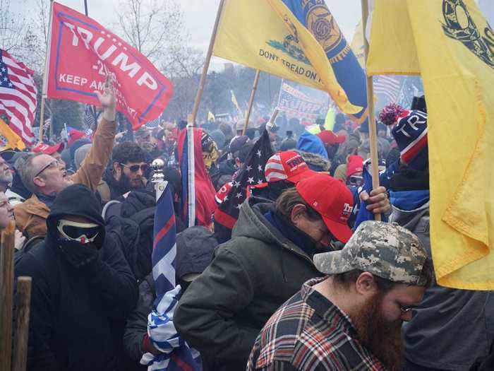 Heads bowed with flags AC.JPG