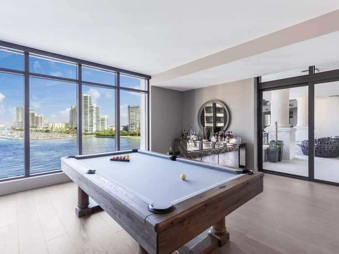 Like the rest of the condo, the billiards room has spectacular views of the bay and Miami Beach.