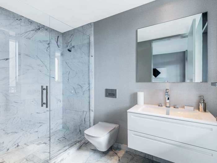 The master bathroom is decked out in white marble.