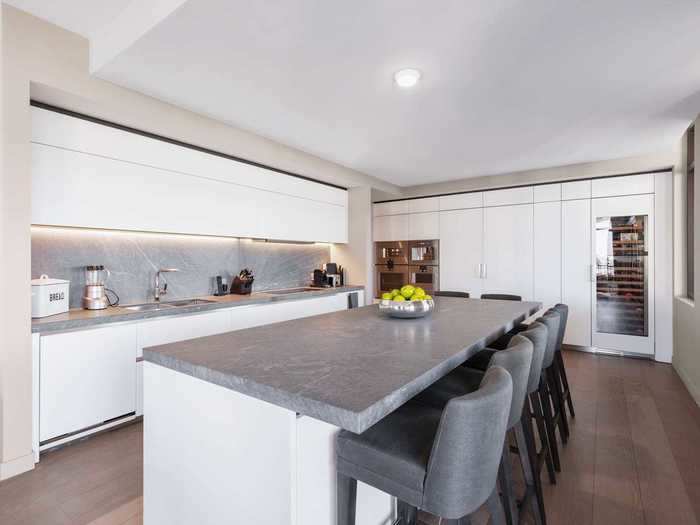 The gourmet kitchen has Gaggenau and Sub-Zero appliances and a large center island.