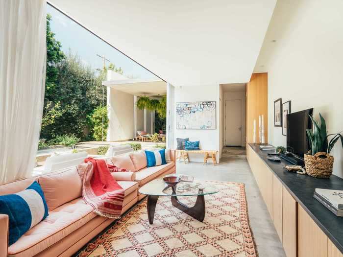 As well as the living room, the ground floor has a long, thin "den" with custom wood cabinets that also looks out over the courtyard.