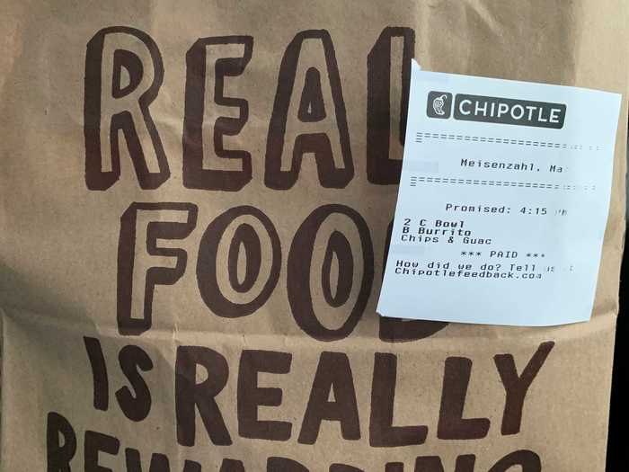 The food comes in a large paper bag with a receipt stapled on it.