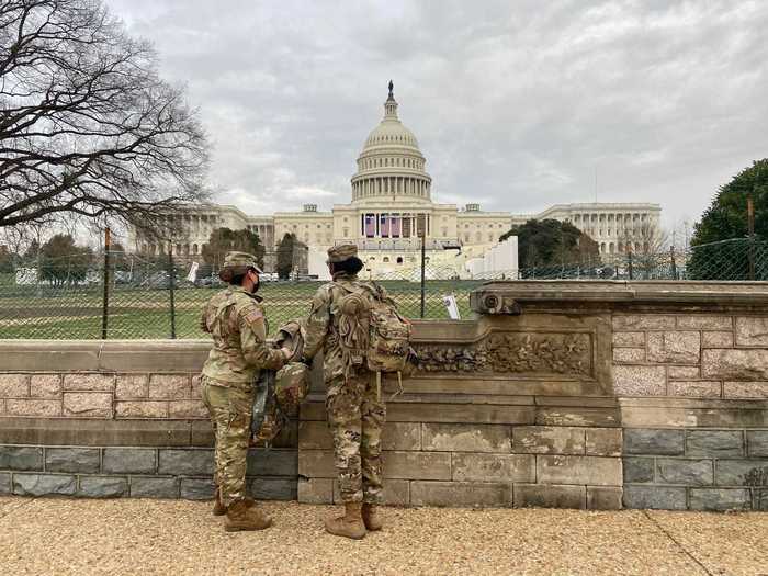 Two female National Guard troops took their position at the western boundary of the new security fence surrounding the Capitol.