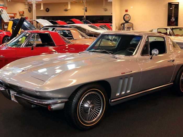 This is a silver 1965 Chevrolet Corvette coupe.