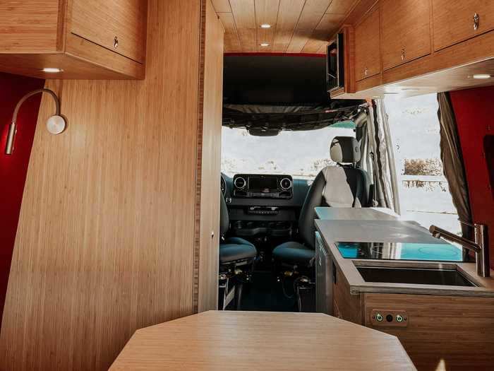 The driver and passenger seats can swivel to be used at the front dining table. The other dining space sits between the bed and the kitchen.