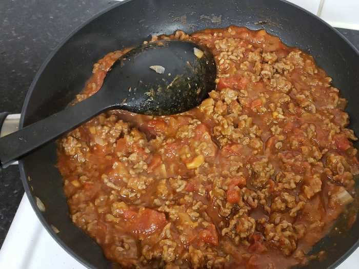 Next, I added crushed tomatoes to the meat.