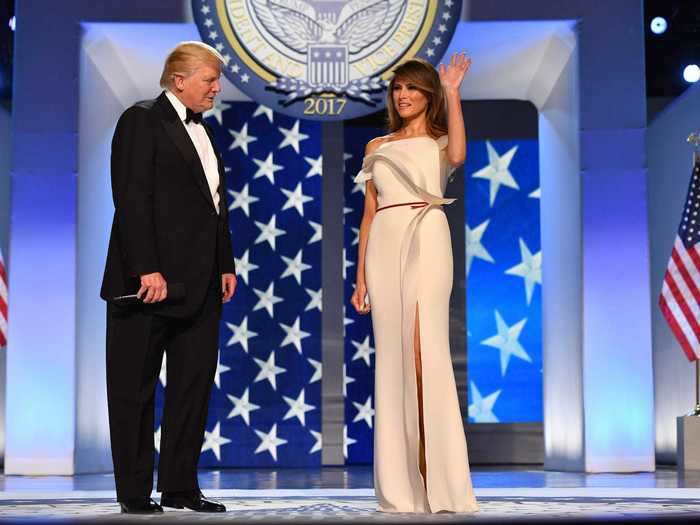 She later wore an off-the-shoulder white gown with slit accompanied with a thin burgundy ribbon to the inaugural balls.