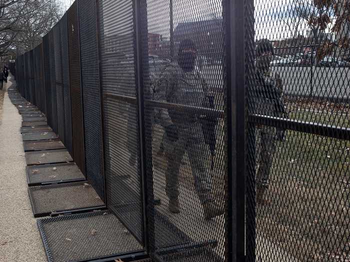 Fences and soldiers surround the Capitol.