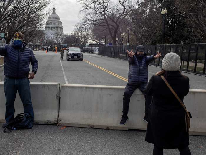 Man showing his middle fingers as his wife take a picture of him, John Hyde, from Oakland, CA. "This is to the entire regime, the 4th Reich," he said.