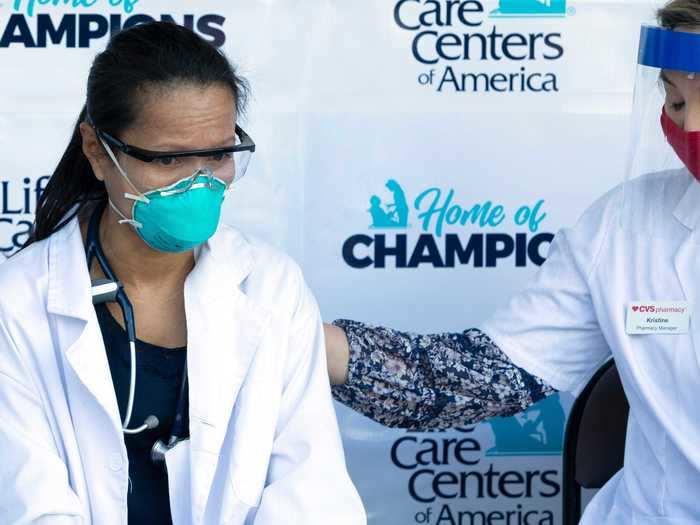 A physician assistant at the Life Care Center of Kirkland receives the coronavirus vaccine.