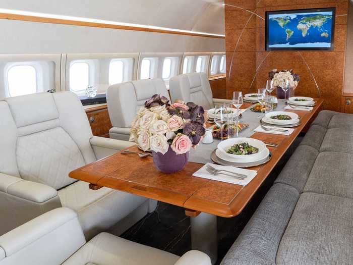 Moving back in the plane, then comes the interchangeable dining and conference area with a six-place table.