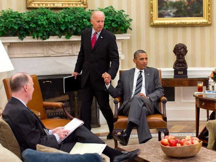 Obama and Biden shook hands as Biden entered the Oval Office for a 2012 meeting.