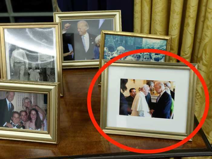 A framed photograph of himself with the pope reminds us of his faith.