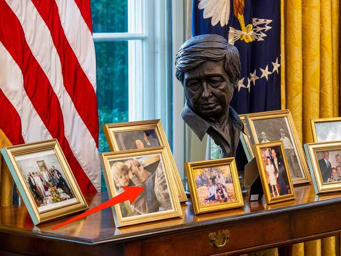 A table covered in family photos shows just how much family means to him.