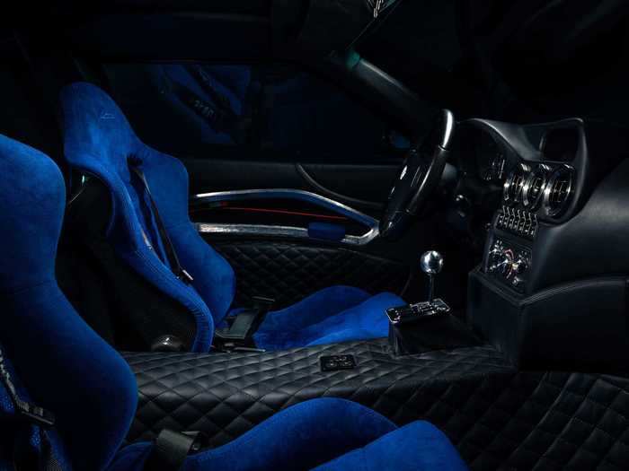 The interior is upholstered in blue Alcantara and quilted black leather.