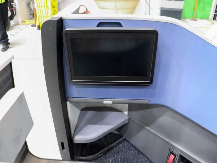 The screen itself can be angled, titled, or both based on customer preference. JetBlue says that customers always reach for the top of the screen to adjust it so a nook was carved out to create a hand hold.