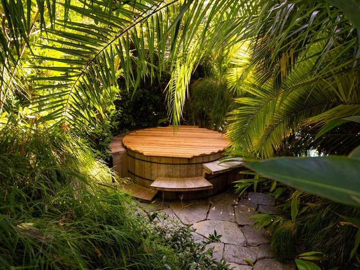 A Japanese-style cedar soaking tub is tucked away in the trees nearby.