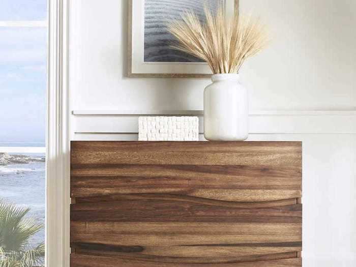 Add visual movement to your home with this tall chest of drawers.