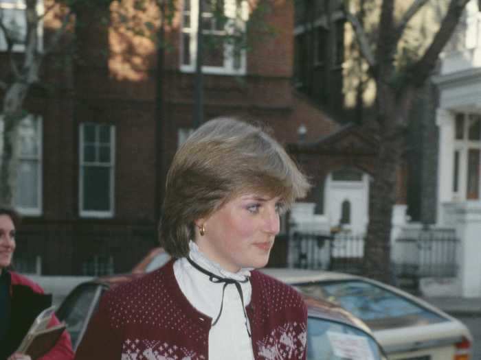 She added a festive twist to her otherwise formal outfit - a pencil skirt and blouse - with a Christmas-themed cardigan for an outing in November 1980.