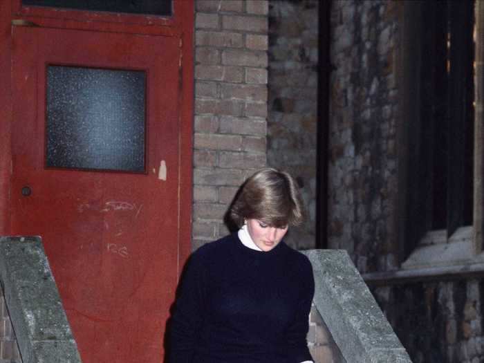 Lady Diana Spencer wrapped up in a black sweater, a plaid skirt, and ballet flats for an outing in London in October 1980.