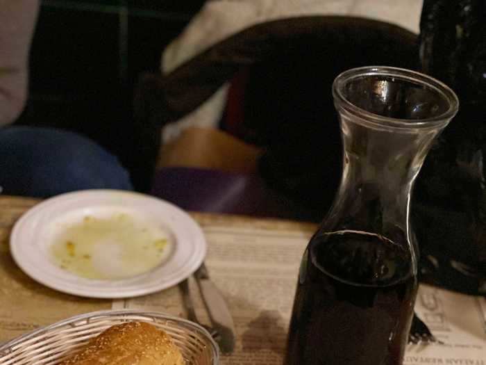 Our meal started with some red wine and bread.