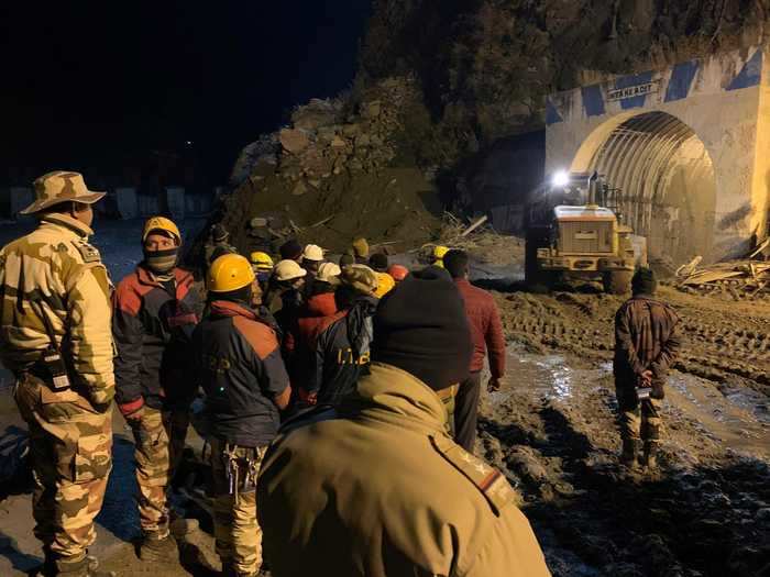 Rescuers are using heavy machinery to try and clear the entrance of a tunnel in which 35 people are believed to be trapped.