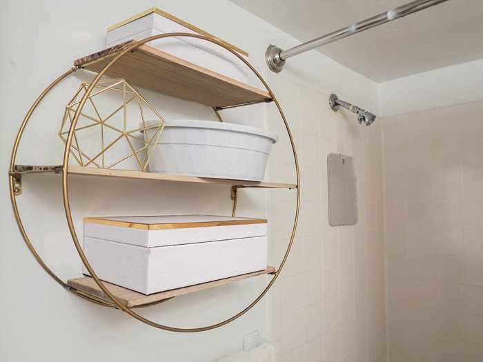 For additional bathroom storage, Abraham installed this wall-mounted shelf.