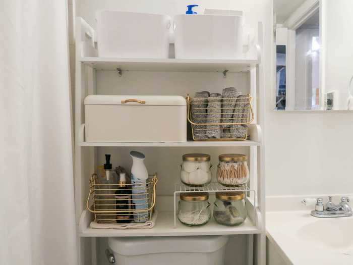 In the bathroom, Abraham uses more vertical storage for her belongings with shelving and stackable bins.