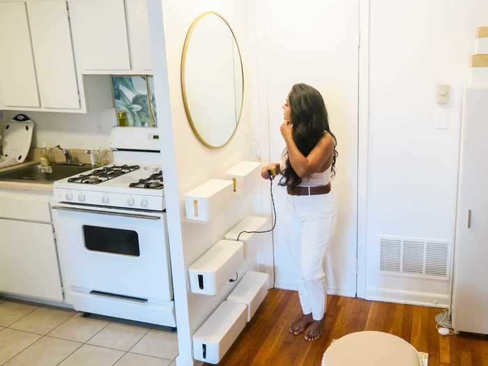 Since her bathroom has no outlets, Abraham created a wall-mounted vanity area for doing hair and makeup.