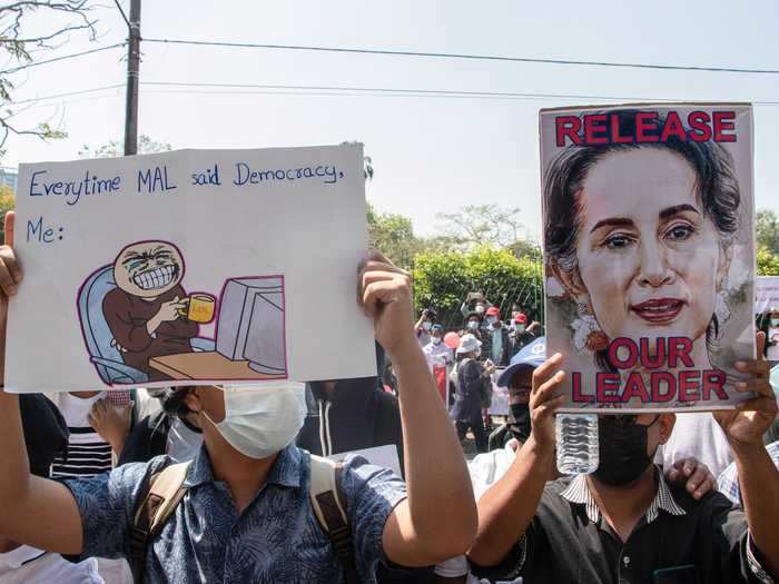 One man held a sign emblazoned with a "rage face" illustration - a meme that became popular on 4Chan.