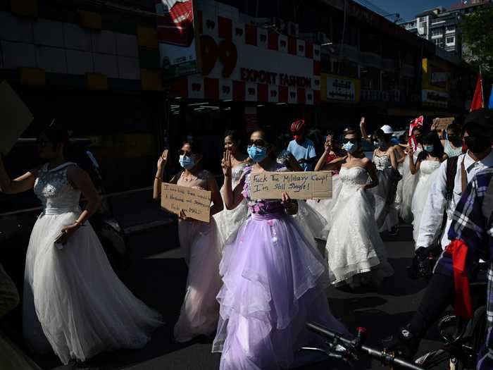 Another "bride" held a sign reading: "F--- the military coup, I