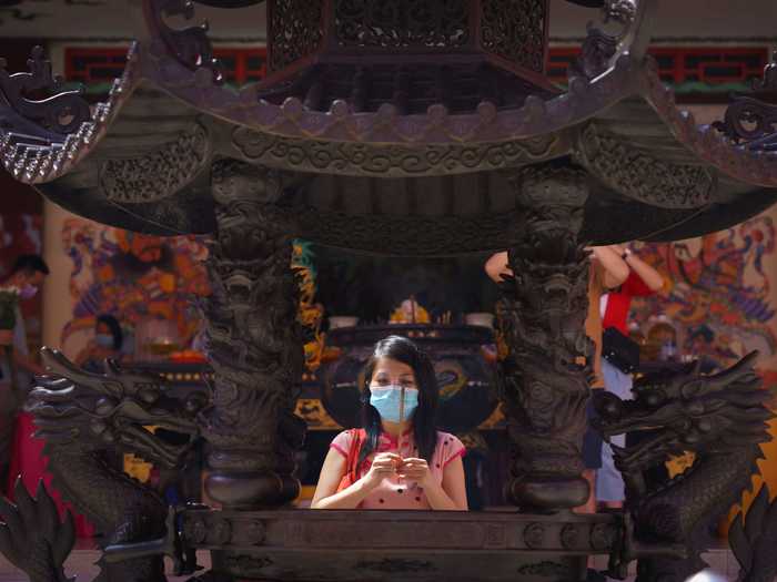 Worshippers wear face coverings when praying at temples for the Lunar New Year.