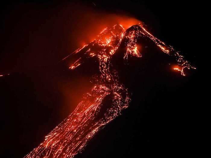 By night time, the clouds had disappeared, but glowing lava continued to stream out of the crater.