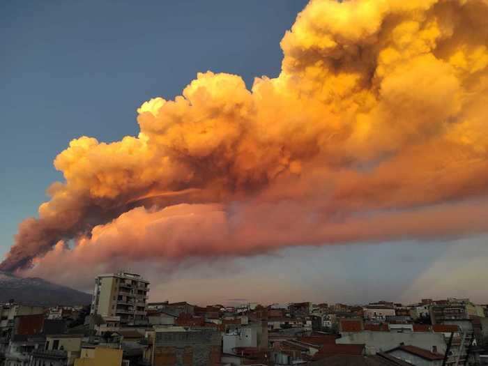 The volcano first erupted on Tuesday, sending rose-colored plumes of ash into the sky...