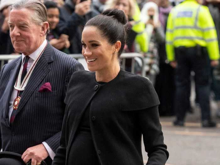 Markle rewore a black Givenchy coat while attending the Association of Commonwealth Universities at the University of London.