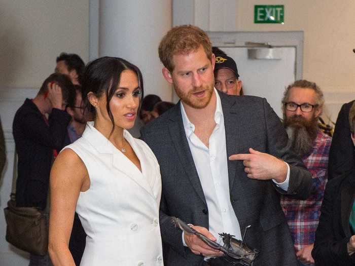 Markle wore a white Maggie Marilyn tuxedo dress to a 2018 New Zealand visit to Courtenay Creative in October.