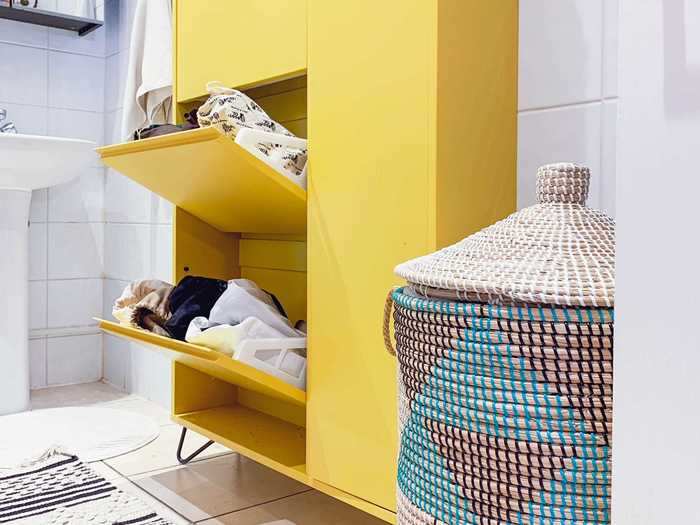 The bathroom has more hidden storage space, and the laundry basket stores her towels.