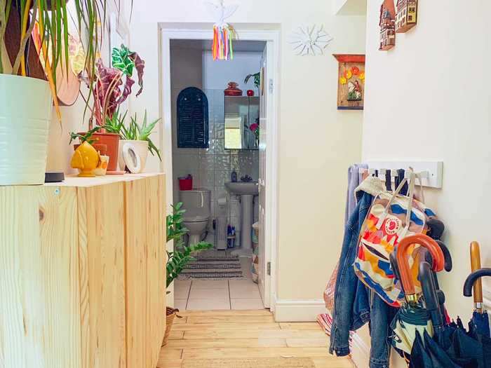 In the entryway, a cabinet against the wall displays her plants and decor ...