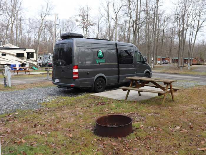 The campsite had a gravel driveway for parking, a patch of cement, a picnic table, and a fire pit.