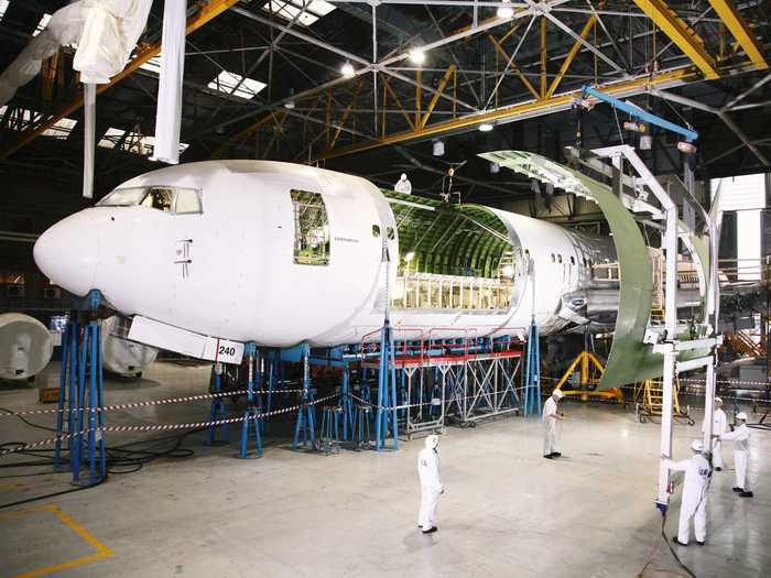 Another key differentiator between a cargo plane and a passenger plane is the cargo door, located on the side of the fuselage. Engineers start by cutting out a section of the fuselage.