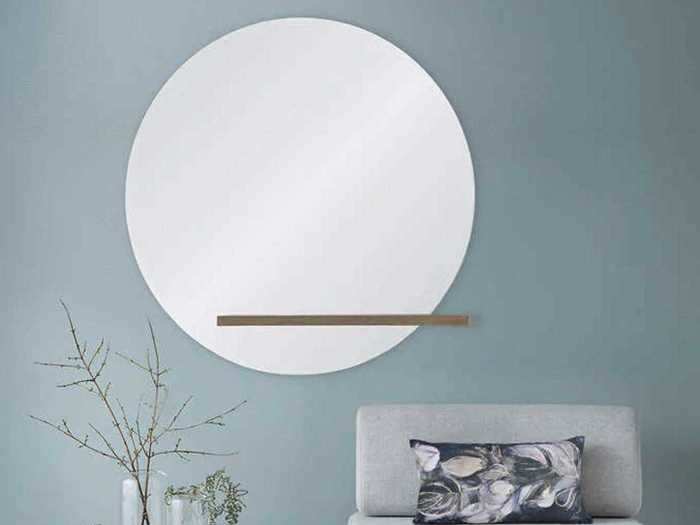 Add functionality and art to your space with this decorative wall mirror.