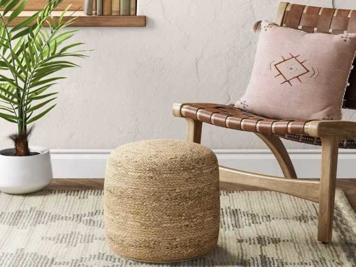 Add texture and functionality to your space with this woven pouf.