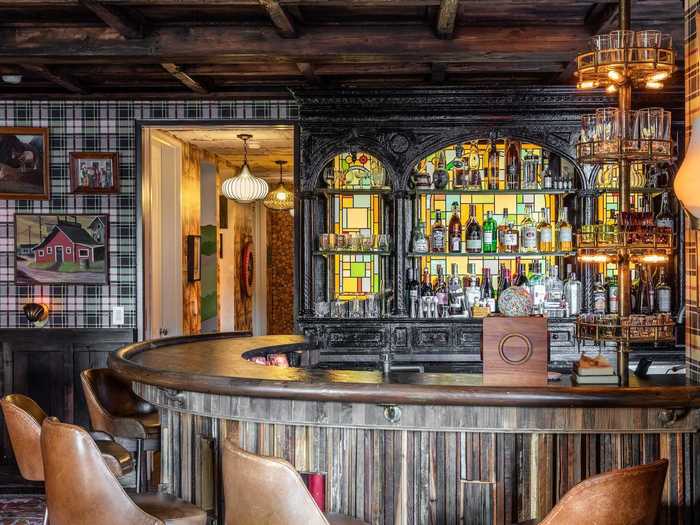 The lounge features a wet bar with custom stained glass on the walls.