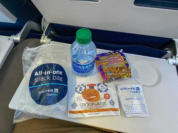 Inside were the essentials including a bottle of water, Stroopwafel, pretzels, and another sanitary wipe.