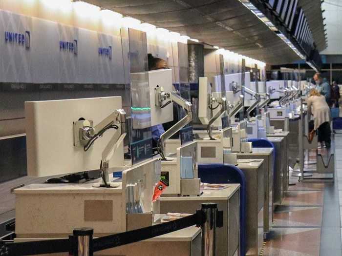 Each check-in station had plexiglass partitions separating United staff from passengers...