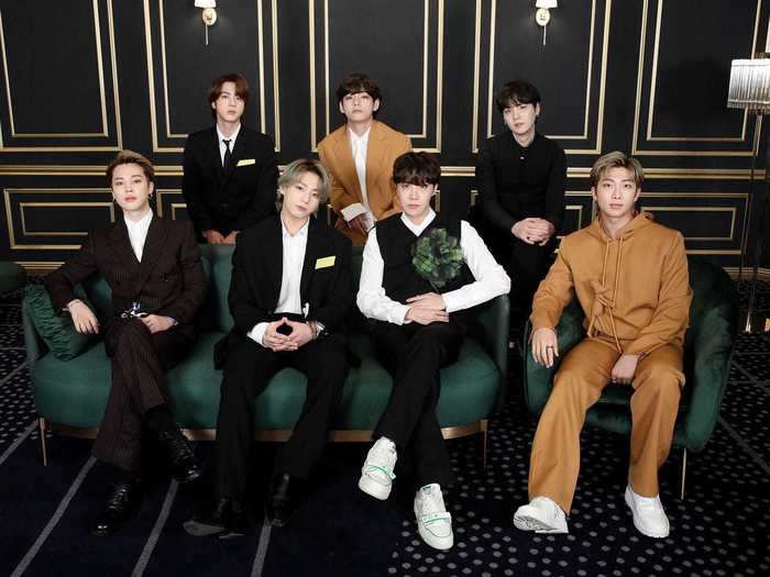 BTS coordinated in black- and camel-colored outfits.