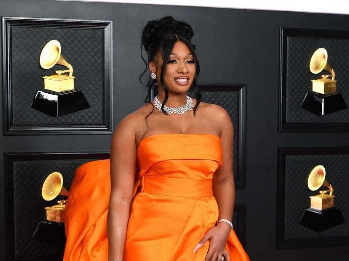 Megan Thee Stallion wore a tangerine-colored dress with a dramatic bow in the back.