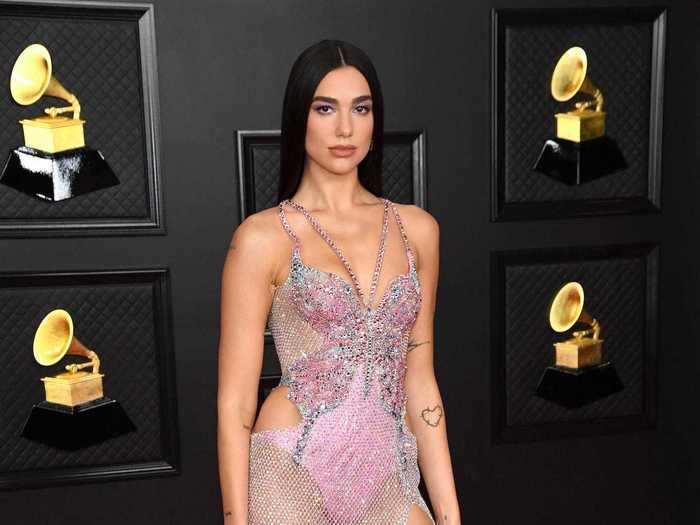 Dua Lipa lit up the red carpet in a sparkling, semi-sheer butterfly dress with bold cutouts.