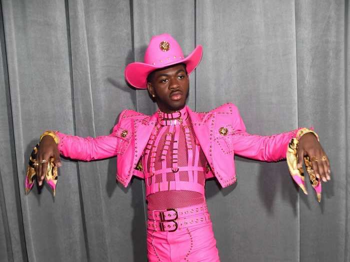 Lil Nas X attended in a neon-pink suit with sharp shoulder pads.